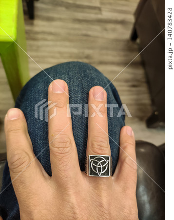 Close up of hand wearing decorative silver ring Close up of hand wearing decorative silver ring 140783428