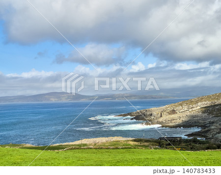 Rocky coastline with blue sea and cloudy sky 140783433