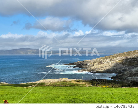 Coastal landscape with green meadow and cloudy sky 140783435