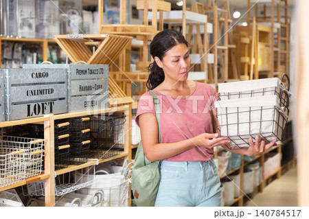 Woman choosing storage basket 140784517