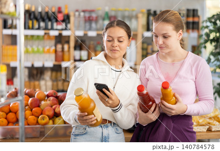 Young women scanning qr code for juices 140784578
