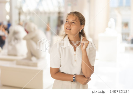 Woman with sheet piece of paper in hands view sculpture in museum hall Woman with sheet piece of paper in hands view sculpture in museum hall 140785124