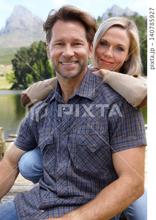 Smile, love and portrait of couple at countryside in summer for vacation, holiday and bonding together. Man, woman and trees with lake for weekend adventure, travel and tourism outdoors in Europe Smile, love and portrait of couple at countryside in summer for vacation, holiday and bonding together. Man, woman and trees with lake for weekend adventure, travel and tourism outdoors in Europe 140785927