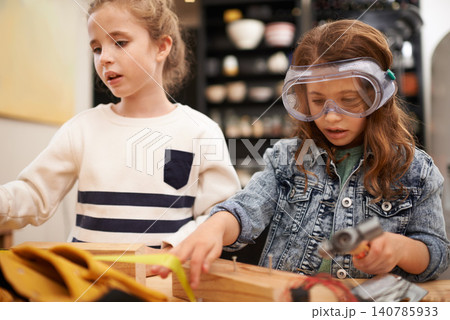 Play, game and girls with construction, wood and learning with fun or education with hobby or creative. Child development, friends or kids with tools or bonding together with hammer or safety glasses 140785933