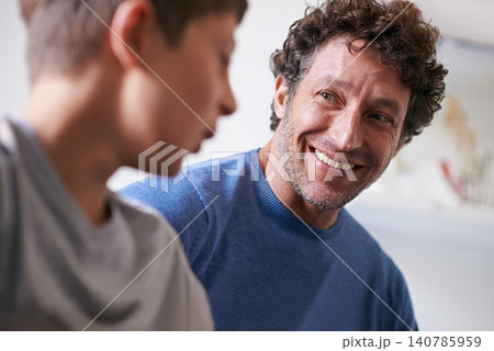 Home, son and father with smile, happiness and proud of child, growth and development of boy. House, adult and man listening to kid talk as parent with love, support and care for family in apartment Home, son and father with smile, happiness and proud of child, growth and development of boy. House, adult and man listening to kid talk as parent with love, support and care for family in apartment 140785959