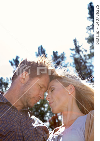 Love, embrace and couple by trees at countryside for adventure, weekend vacation and travel together. Sky, man and woman outdoors in nature for summer holiday, romance and getaway trip in low angle Love, embrace and couple by trees at countryside for adventure, weekend vacation and travel together. Sky, man and woman outdoors in nature for summer holiday, romance and getaway trip in low angle 140786225