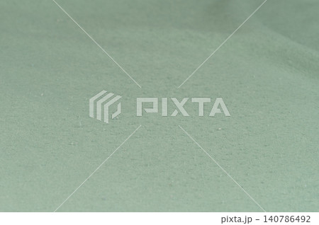 Cloth lint on green surface Cloth lint on green surface 140786492