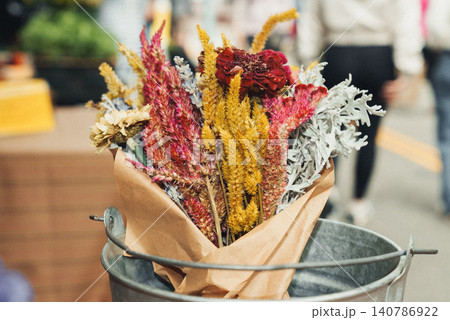 Dry flowers in rustic bucket, wrapped in brown paper Dry flowers in rustic bucket, wrapped in brown paper 140786922
