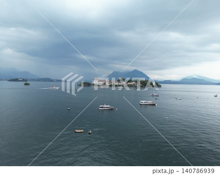 Overcast sky looms over calm lake waters Overcast sky looms over calm lake waters 140786939