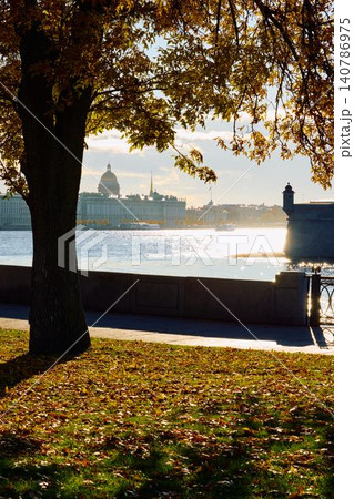 Isaac cathedral, Winter Palace, picturesque metal railings with a double-headed eagle and the crown of the Russian Empire on embankment in St. Petersburg, autumn sunset, incredible sun glare, Russia Isaac cathedral, Winter Palace, picturesque metal railings with a double-headed eagle and the crown of the Russian Empire on embankment in St. Petersburg, autumn sunset, incredible sun glare, Russia 140786975