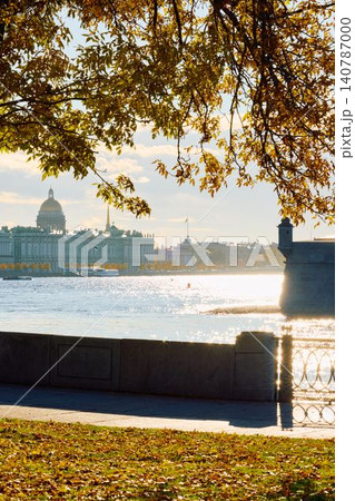 Isaac cathedral, Winter Palace, picturesque metal railings with a double-headed eagle and the crown of the Russian Empire on embankment in St. Petersburg, autumn sunset, incredible sun glare, Russia Isaac cathedral, Winter Palace, picturesque metal railings with a double-headed eagle and the crown of the Russian Empire on embankment in St. Petersburg, autumn sunset, incredible sun glare, Russia 140787000