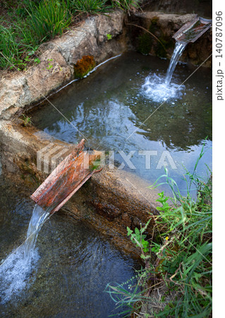 Rustic waterway conduit made of stone and tile Rustic waterway conduit made of stone and tile 140787096