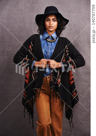 Fashion, cowgirl or woman with confidence in portrait, studio or cool clothing in culture on grey background. Native American person, unique or stylish model with pride, boho style or western poncho Fashion, cowgirl or woman with confidence in portrait, studio or cool clothing in culture on grey background. Native American person, unique or stylish model with pride, boho style or western poncho 140787709