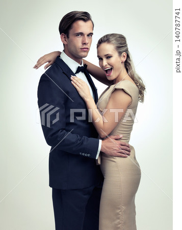 Couple, studio and portrait with smile, rich and vintage for luxury retro romance. Man, woman and model with tuxedo, glamour and confidence for classy black tie event isolated on white background 140787741