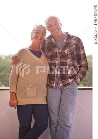 Senior couple, smile and portrait on balcony with hug, love and outdoor with connection for retirement. Elderly woman, old man and embrace on patio with pride, care and happy at apartment in Germany Senior couple, smile and portrait on balcony with hug, love and outdoor with connection for retirement. Elderly woman, old man and embrace on patio with pride, care and happy at apartment in Germany 140787840