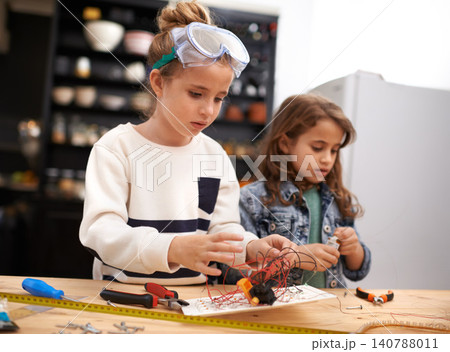 Child, play and tools for robotics, construction and design for busy and bonding for childhood game. Kids or friend for sibling with wire and tape for crafts, diy or fun indoor for tasks and cute Child, play and tools for robotics, construction and design for busy and bonding for childhood game. Kids or friend for sibling with wire and tape for crafts, diy or fun indoor for tasks and cute 140788011