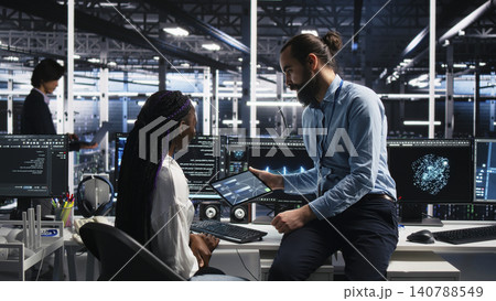 System administrator and employee programs on a computer workstation in a server hub with generative AI assistance. System administrator and employee programs on a computer workstation in a server hub with generative AI assistance. 140788549