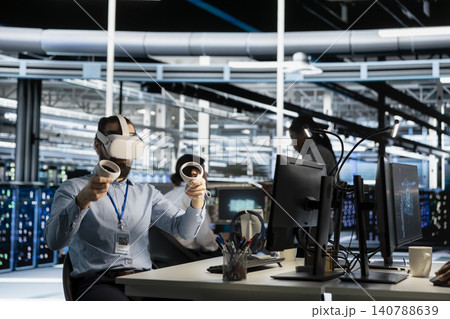 Data center engineer uses a VR headset to inspect AI neural networks and server systems in a high-tech facility. Data center engineer uses a VR headset to inspect AI neural networks and server systems in a high-tech facility. 140788639