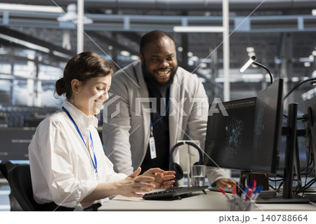 Excited data center engineer celebrates successful AI implementation and improved system results in a server hub. 140788664