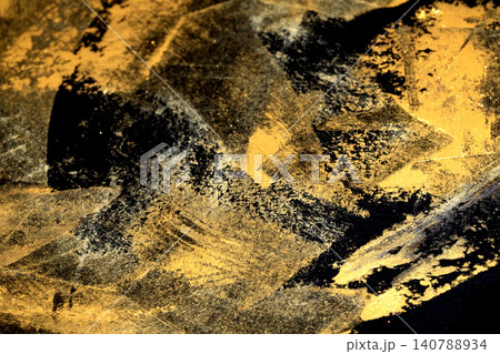 Gold metallic shiny paint leaf on black background Gold metallic shiny paint leaf on black background 140788934