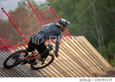 Close-up downhill racer rides turn Close-up downhill racer rides turn 140793134