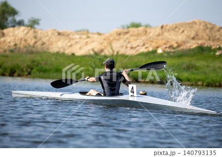 Athlete kayaker paddling Athlete kayaker paddling 140793135