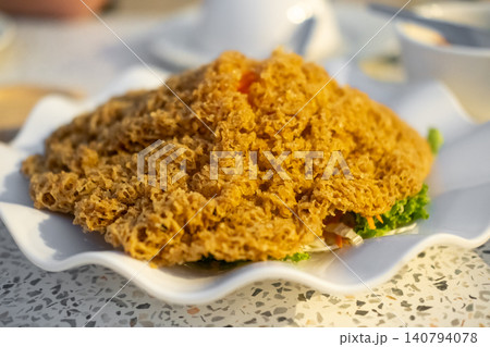 Crispy fluffy fried fish served with a green mango salad, Thai food Crispy fluffy fried fish served with a green mango salad, Thai food 140794078