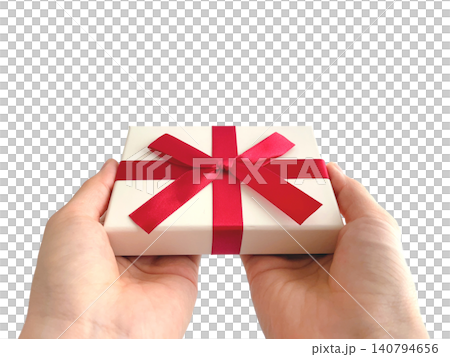 A woman's hand offering a gift with a red ribbon. A woman's hand offering a gift with a red ribbon. 140794656