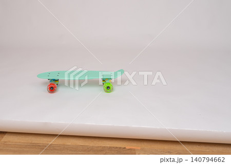 Small plastic finger skateboard toy designed for extreme hand finger tricks, isolated on a bright neutral studio backdrop. Youth culture and hobby concept. Cute tiny skateboard prop or kids toy with Small plastic finger skateboard toy designed for extreme hand finger tricks, isolated on a bright neutral studio backdrop. Youth culture and hobby concept. Cute tiny skateboard prop or kids toy with 140794662