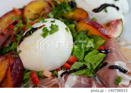 Gourmet Peach and Balsamic Glaze Salad with Fresh Cheese, Cured Meat, and Leafy Greens 140796655