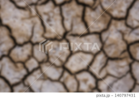 Blurred Texture Background of Dry Cracked Earth Ground in Drought Season Blurred Texture Background of Dry Cracked Earth Ground in Drought Season 140797431