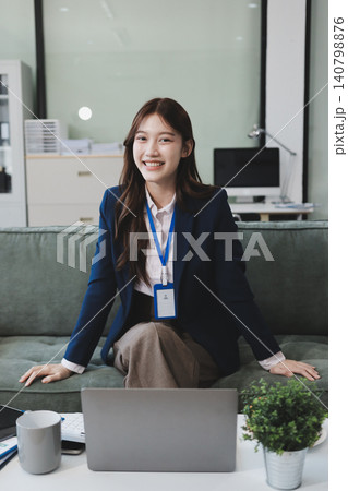 Asian businesswoman sitting at work using laptop talking and consulting in office 140798876
