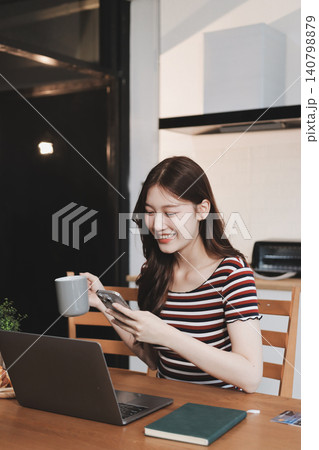 Asian woman using computer remote for business studying, watching online virtual webinar training meeting, video call. asian business woman talking on laptop in home office. Banner, copy space 140798879
