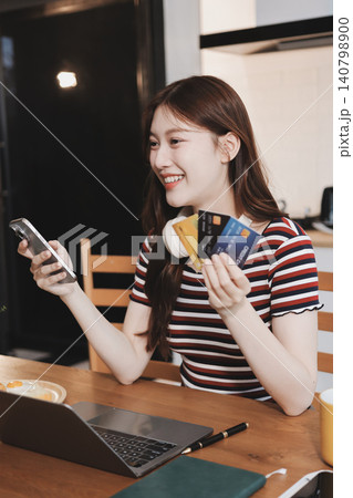 Happiness Entrepreneur beautiful business asian young woman wear casual use mobile phone for shopping online enjoy with social media and laptop at home.Small Business Startup.online banking Happiness Entrepreneur beautiful business asian young woman wear casual use mobile phone for shopping online enjoy with social media and laptop at home.Small Business Startup.online banking 140798900