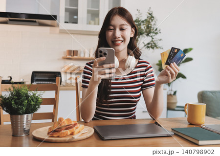 Happiness Entrepreneur beautiful business asian young woman wear casual use mobile phone for shopping online enjoy with social media and laptop at home.Small Business Startup.online banking Happiness Entrepreneur beautiful business asian young woman wear casual use mobile phone for shopping online enjoy with social media and laptop at home.Small Business Startup.online banking 140798902