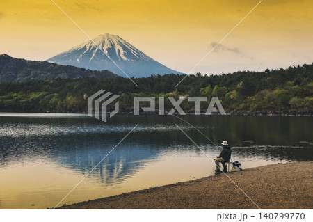 Man fishing at lake Saiko shore by mount fuji at sunrise, Yamanash 140799770