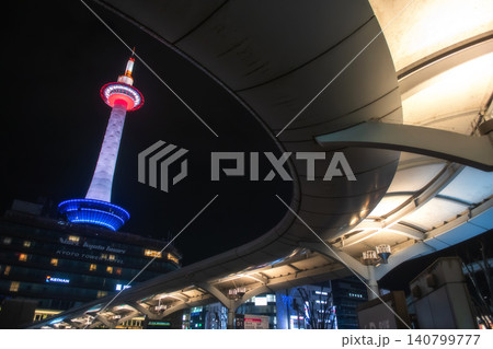 Kyoto tower at night from Kyoto Station`s bus terminal curve roof 140799777