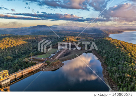 Aerial view showcasing the Lake Keepit dam wall and surrounding rural landscape, highlighting the scale of the reservoir, engineering infrastructure and tranquil lakeside setting in NSW, Australia. Aerial view showcasing the Lake Keepit dam wall and surrounding rural landscape, highlighting the scale of the reservoir, engineering infrastructure and tranquil lakeside setting in NSW, Australia. 140800573