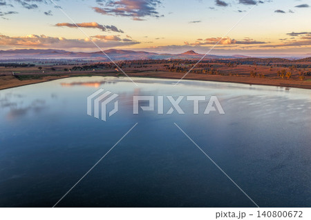 Aerial view at dawn over Lake Keepit featuring the dam wall, expansive reservoir and a foggy rural landscape beneath soft golden morning light in NSW, Australia. Aerial view at dawn over Lake Keepit featuring the dam wall, expansive reservoir and a foggy rural landscape beneath soft golden morning light in NSW, Australia. 140800672