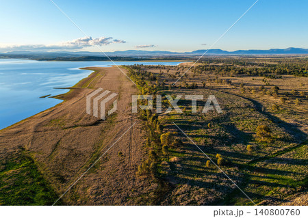 Aerial scene showcasing Lake Keepit and the surrounding rural landscape, highlighting the expansive reservoir, natural shoreline and peaceful countryside in NSW, Australia. 140800760
