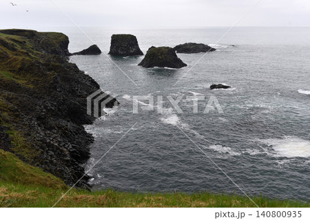 Volcanic sea stacks rising from the ocean near Arnarstapi cliffs, Iceland Volcanic sea stacks rising from the ocean near Arnarstapi cliffs, Iceland 140800935
