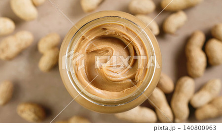 Open Jar of Peanut Butter on Warm Beige Background, Top View Open Jar of Peanut Butter on Warm Beige Background, Top View 140800963