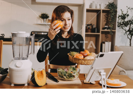 Woman preparing green smoothie in bright kitchen with fresh fruits and vegetables, healthy eating lifestyle moment in natural daylight Woman preparing green smoothie in bright kitchen with fresh fruits and vegetables, healthy eating lifestyle moment in natural daylight 140803638