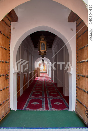 A corridor with red carpets guides the eye through the arches of the Grand Mosque of Meknes. A corridor with red carpets guides the eye through the arches of the Grand Mosque of Meknes. 140804419