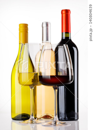 Different wine bottles and glasses on white background Different wine bottles and glasses on white background 140804639