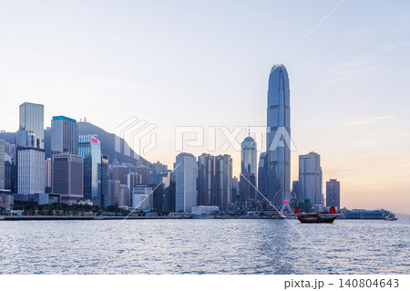 Hong Kong city skyline at sunset with glowing sky and skyscrapers 140804643