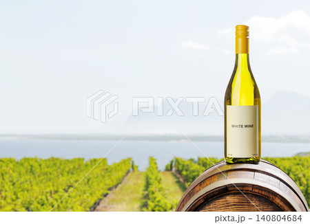 White wine bottle with vineyard background 140804684