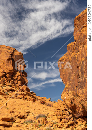 Red sandstone desert cliffs with blue sky dramatic rock landscape 140804729