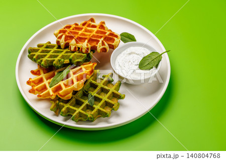 Vegan spinach waffles top view Vegan spinach waffles top view 140804768