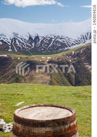 Wooden barrel with mountains in background Wooden barrel with mountains in background 140804816
